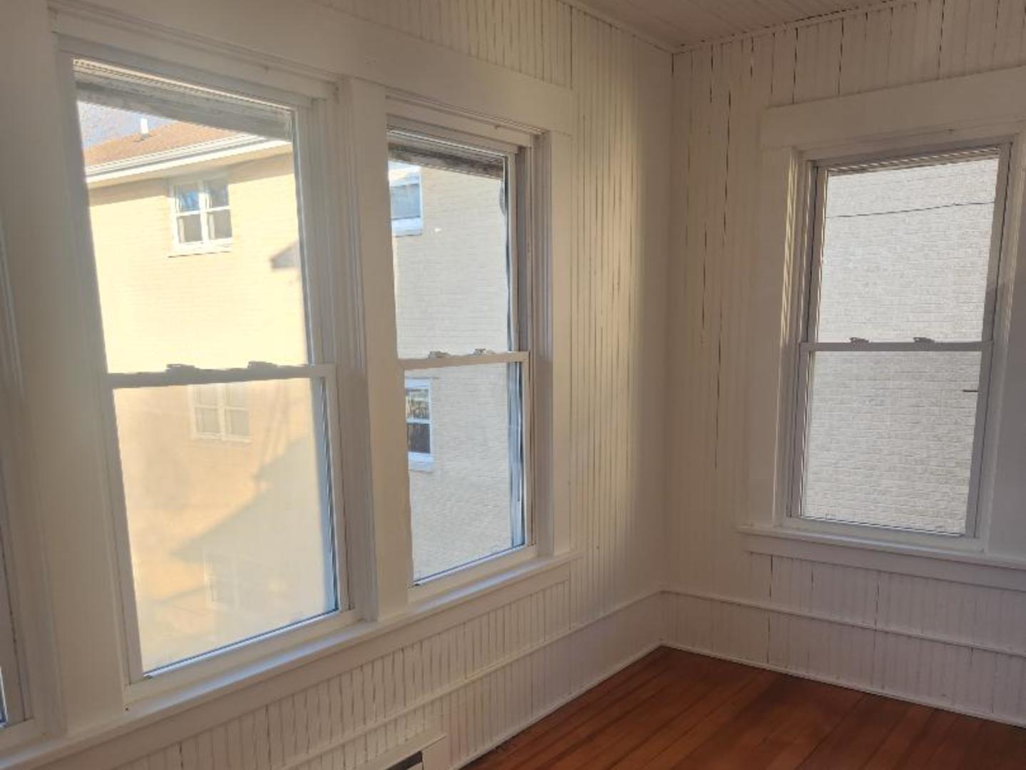 345 Augusta Avenue DeKalb, IL 60115 - Photo 11 of 25 a view of an empty room with wooden floor and a window
