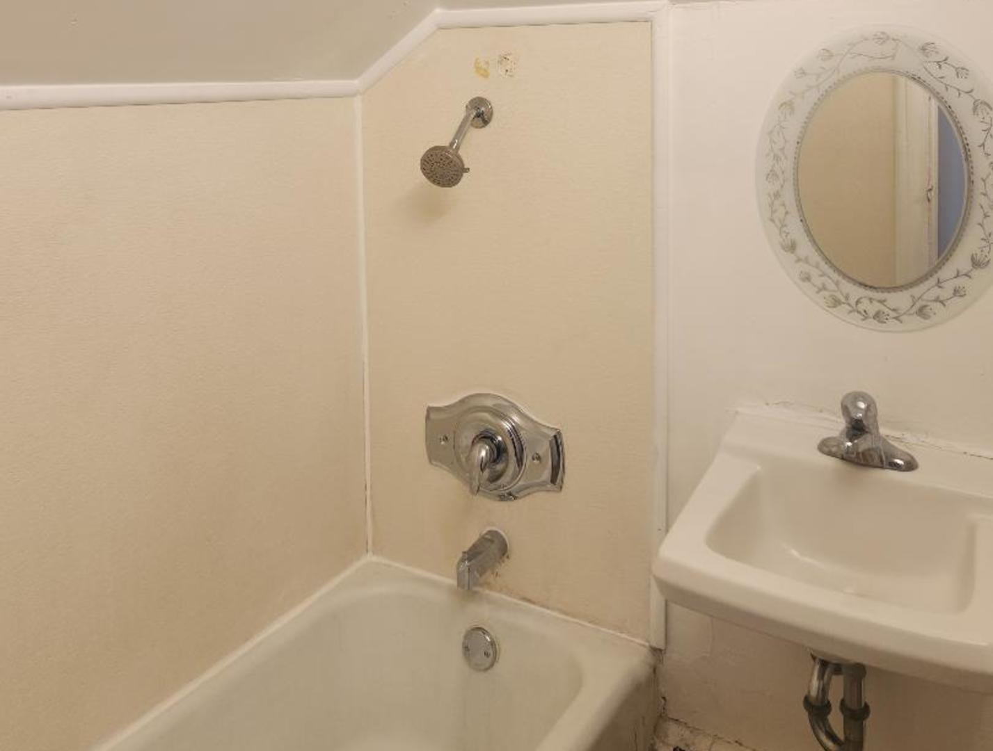 345 Augusta Avenue DeKalb, IL 60115 - Photo 12 of 25 a bathroom with a sink and a mirror