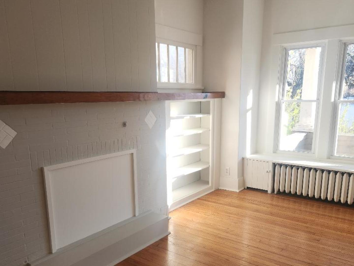 345 Augusta Avenue DeKalb, IL 60115 - Photo 14 of 25 an empty room with wooden floor and windows
