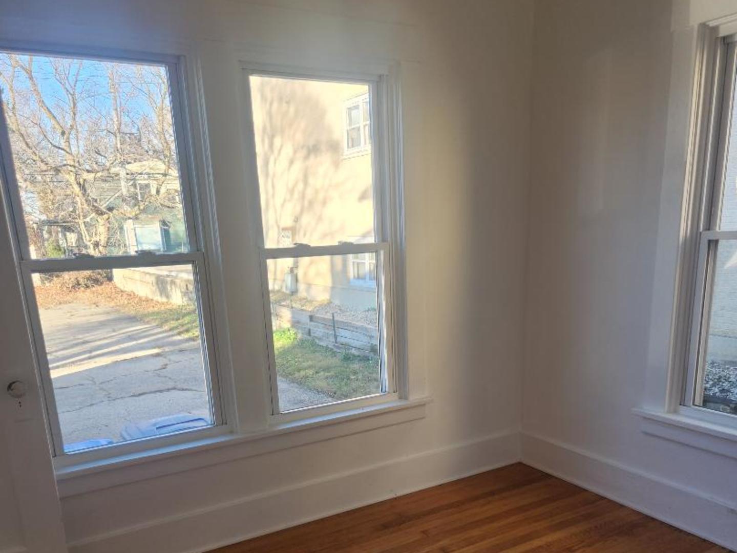 345 Augusta Avenue DeKalb, IL 60115 - Photo 17 of 25 a view of an empty room with wooden floor and a window