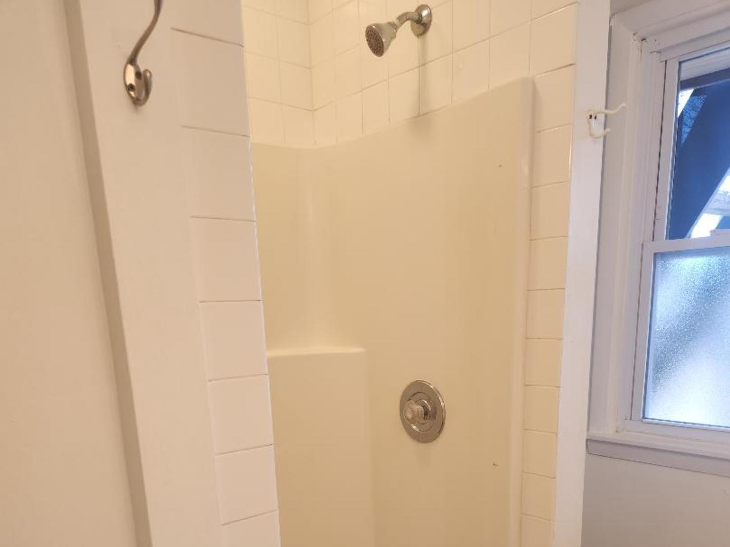 345 Augusta Avenue DeKalb, IL 60115 - Photo 7 of 25 a bathroom with a shower