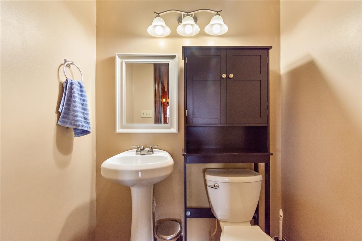 1510 Penile Hill Road Decherd, TN 37324 - Photo 14 of 34 a bathroom with a toilet a sink and mirror