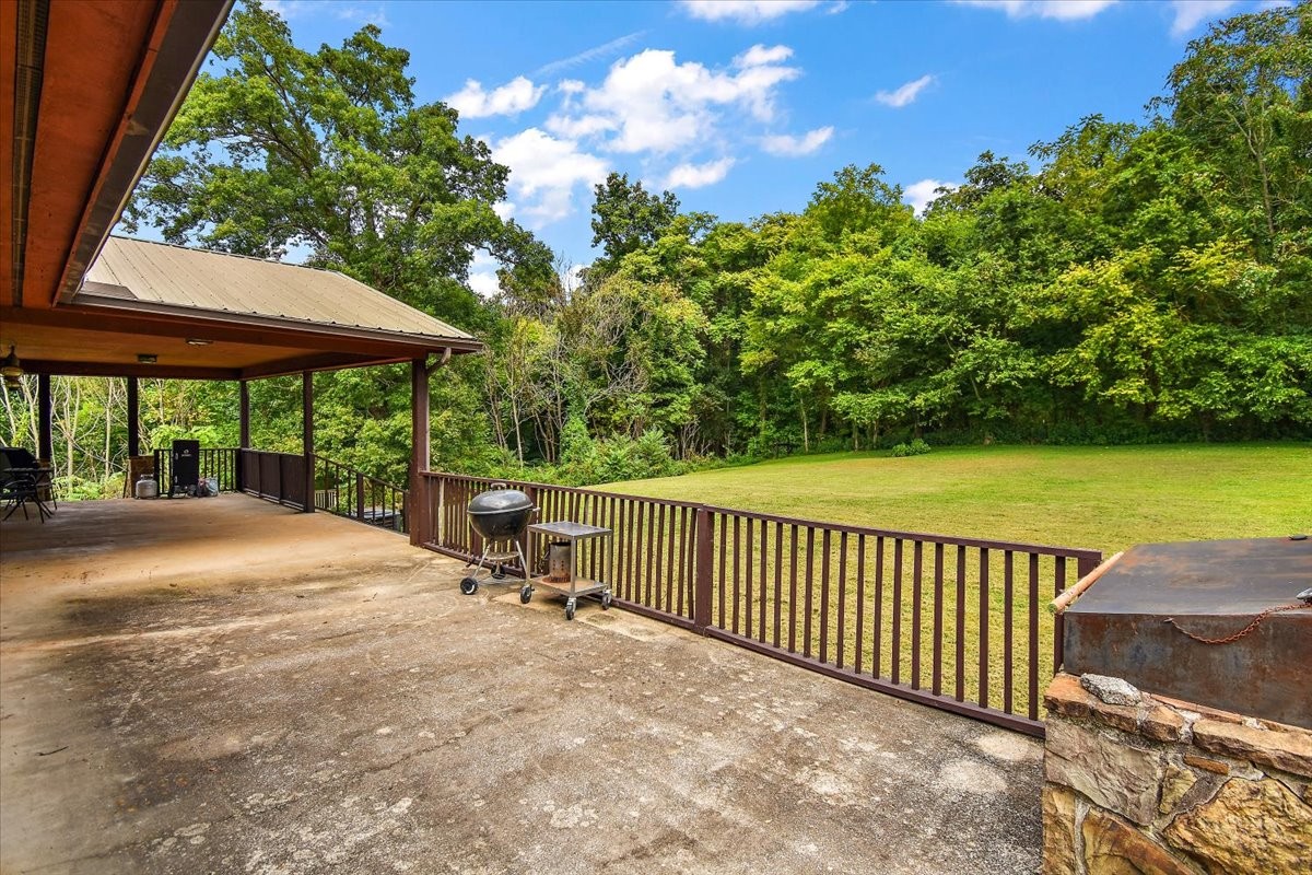 1510 Penile Hill Road Decherd, TN 37324 - Photo 26 of 34 a view of a patio with a table & chairs under an umbrella