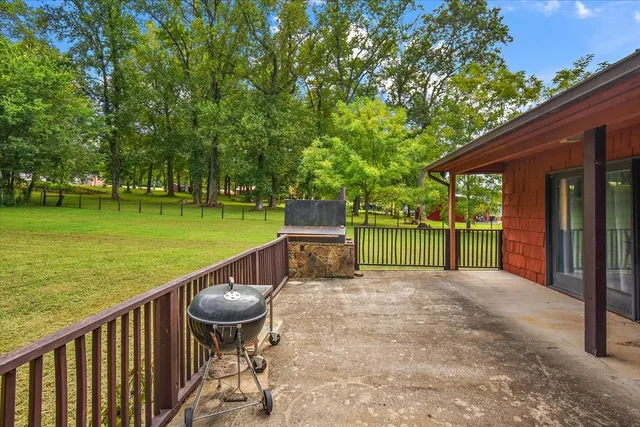a view of a porch with furniture and backyard