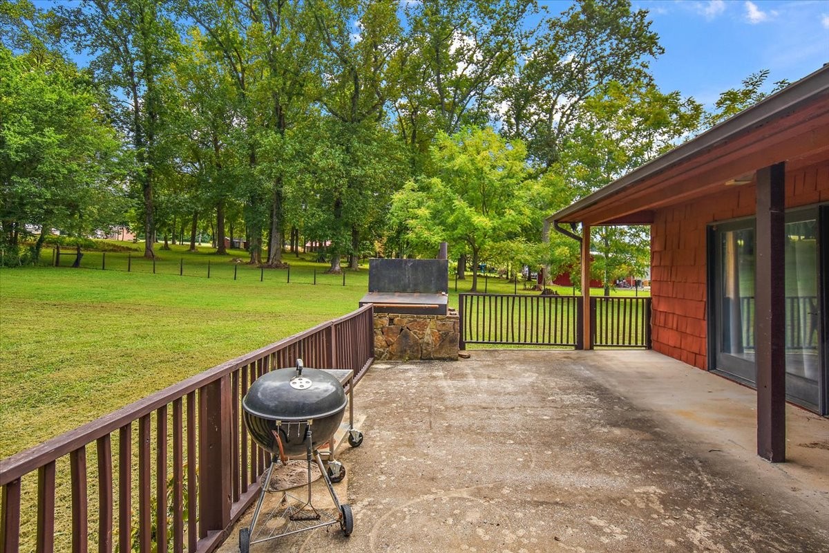 1510 Penile Hill Road Decherd, TN 37324 - Photo 27 of 34 a view of a deck with a table and chairs next to a yard