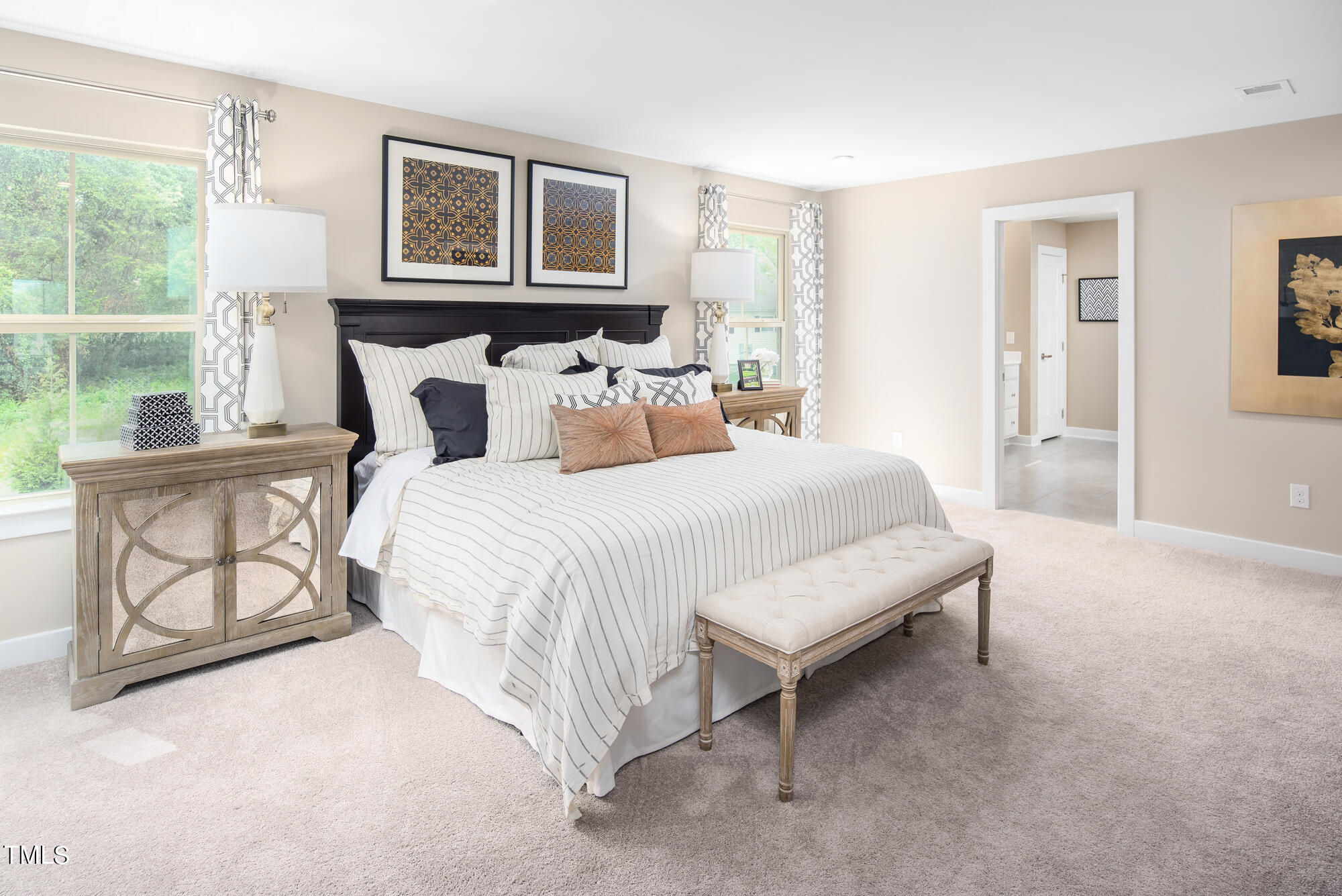 8909 Stratus Street Willow Spring, NC 27592 - Photo 19 of 30 a bedroom with a bed a table and painting