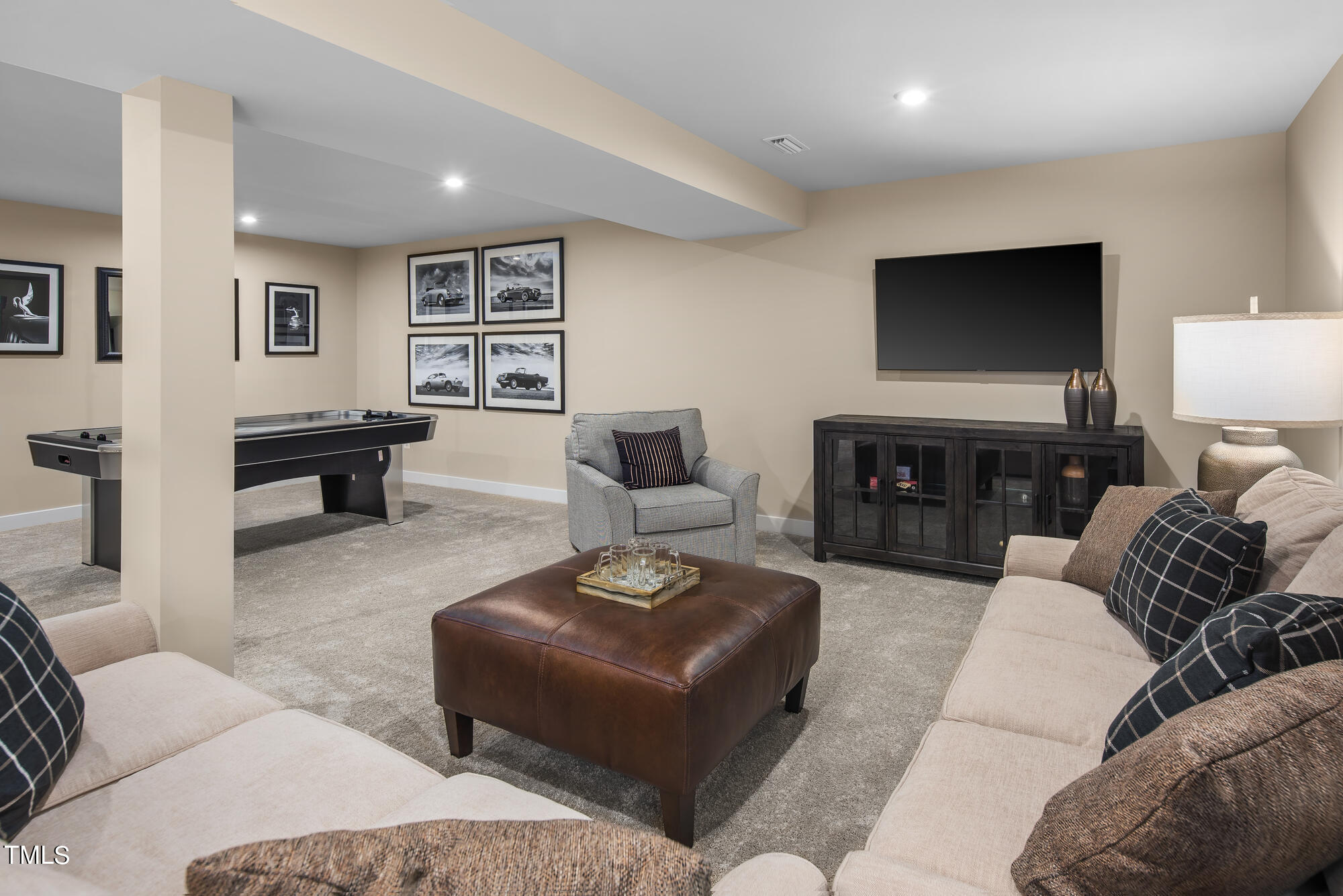 8909 Stratus Street Willow Spring, NC 27592 - Photo 30 of 30 a living room with furniture and a flat screen tv