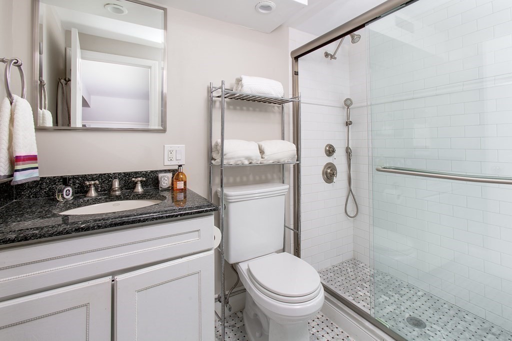 40 Joy Street, Unit 2 Boston, MA 02114 - Photo 9 of 13 a bathroom with a granite countertop sink toilet and shower