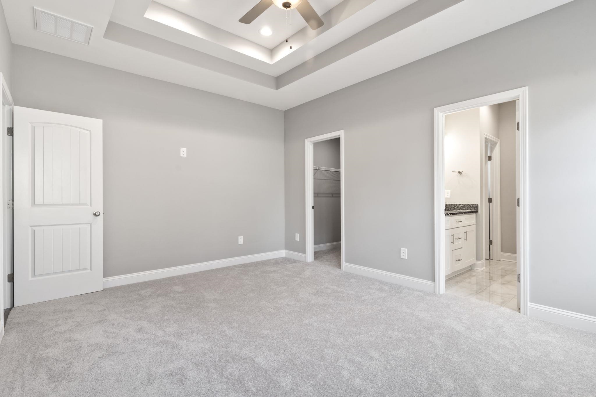 565 Timber Creek Drive Loris, SC 29569 - Photo 13 of 37 Unfurnished bedroom featuring a spacious closet, light colored carpet, ceiling fan, and a raised ceiling
