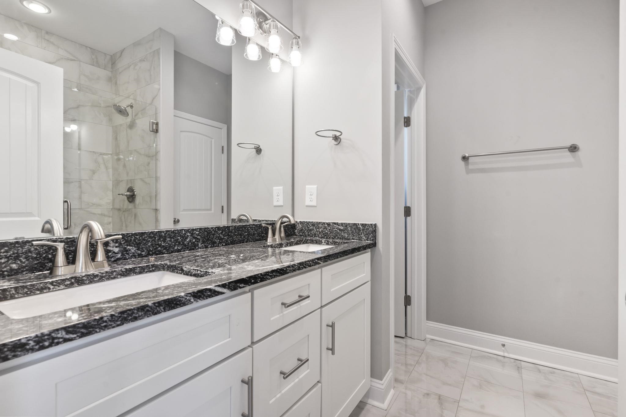 565 Timber Creek Drive Loris, SC 29569 - Photo 14 of 37 Full bathroom featuring double vanity, a shower stall, and light marble finish floors