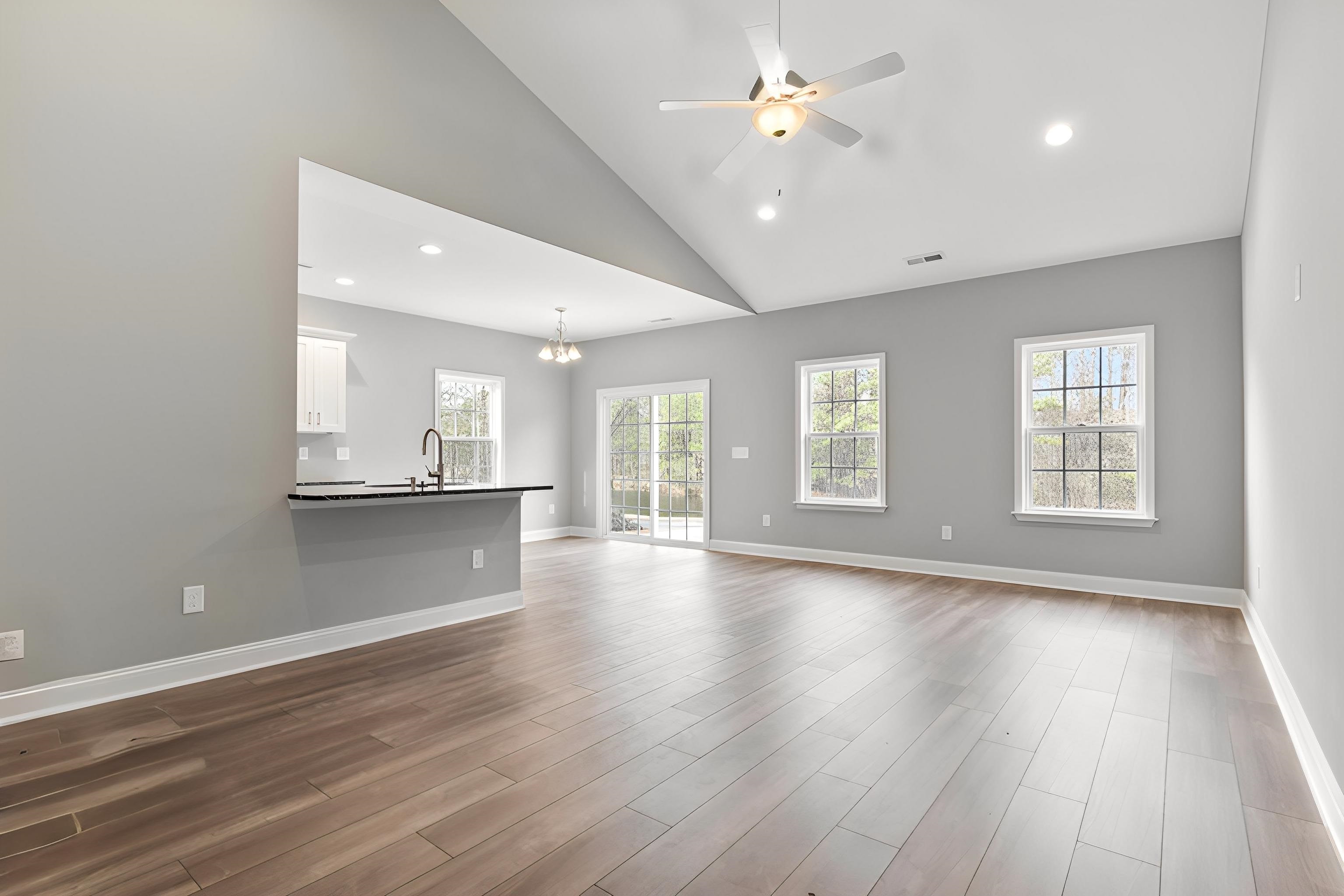 565 Timber Creek Drive Loris, SC 29569 - Photo 16 of 37 Unfurnished living room with recessed lighting, a chandelier, high vaulted ceiling, dark wood-type flooring, and a ceiling fan