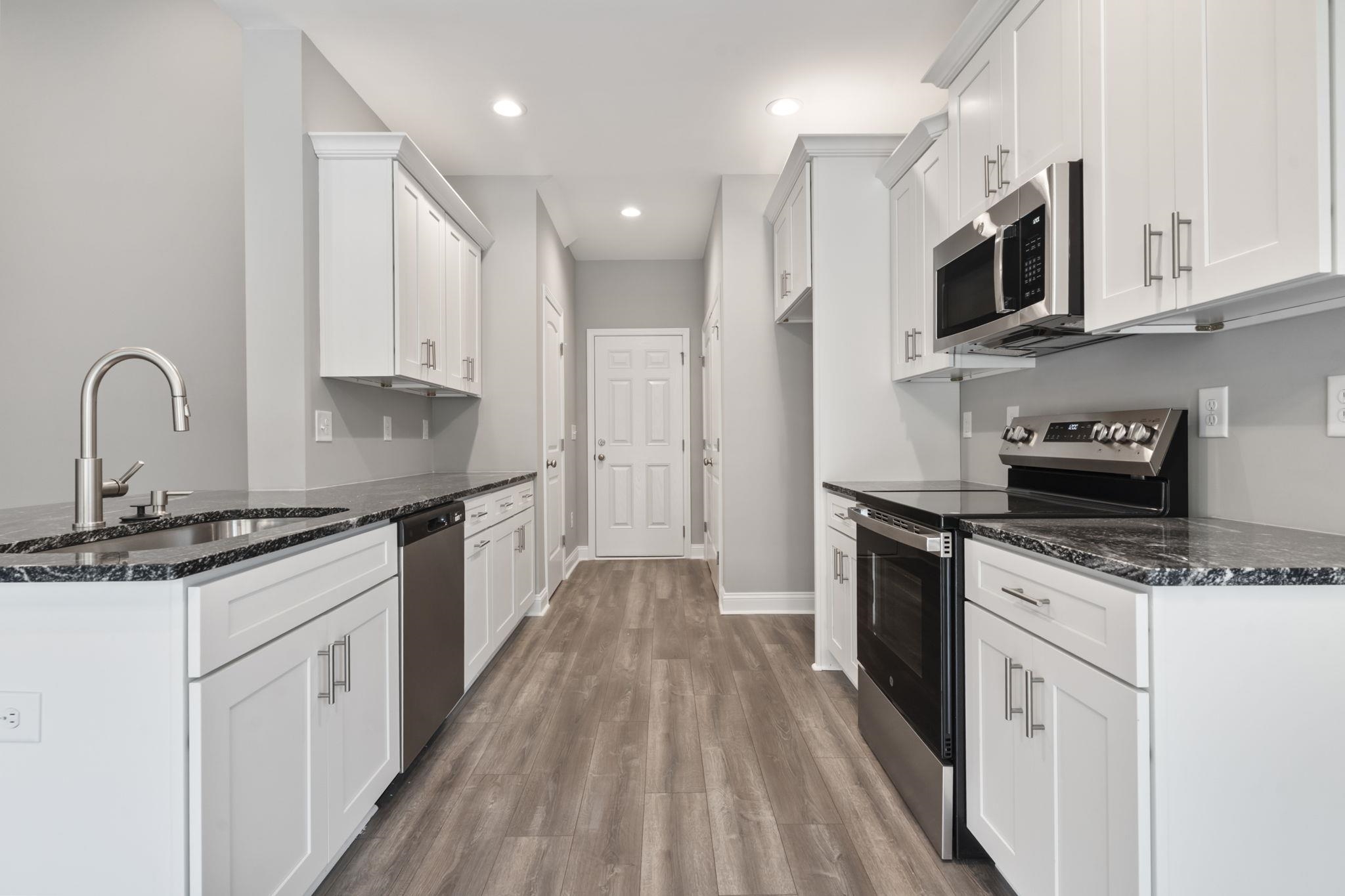 565 Timber Creek Drive Loris, SC 29569 - Photo 20 of 37 Kitchen featuring stainless steel appliances, dark stone countertops, white cabinets, and recessed lighting