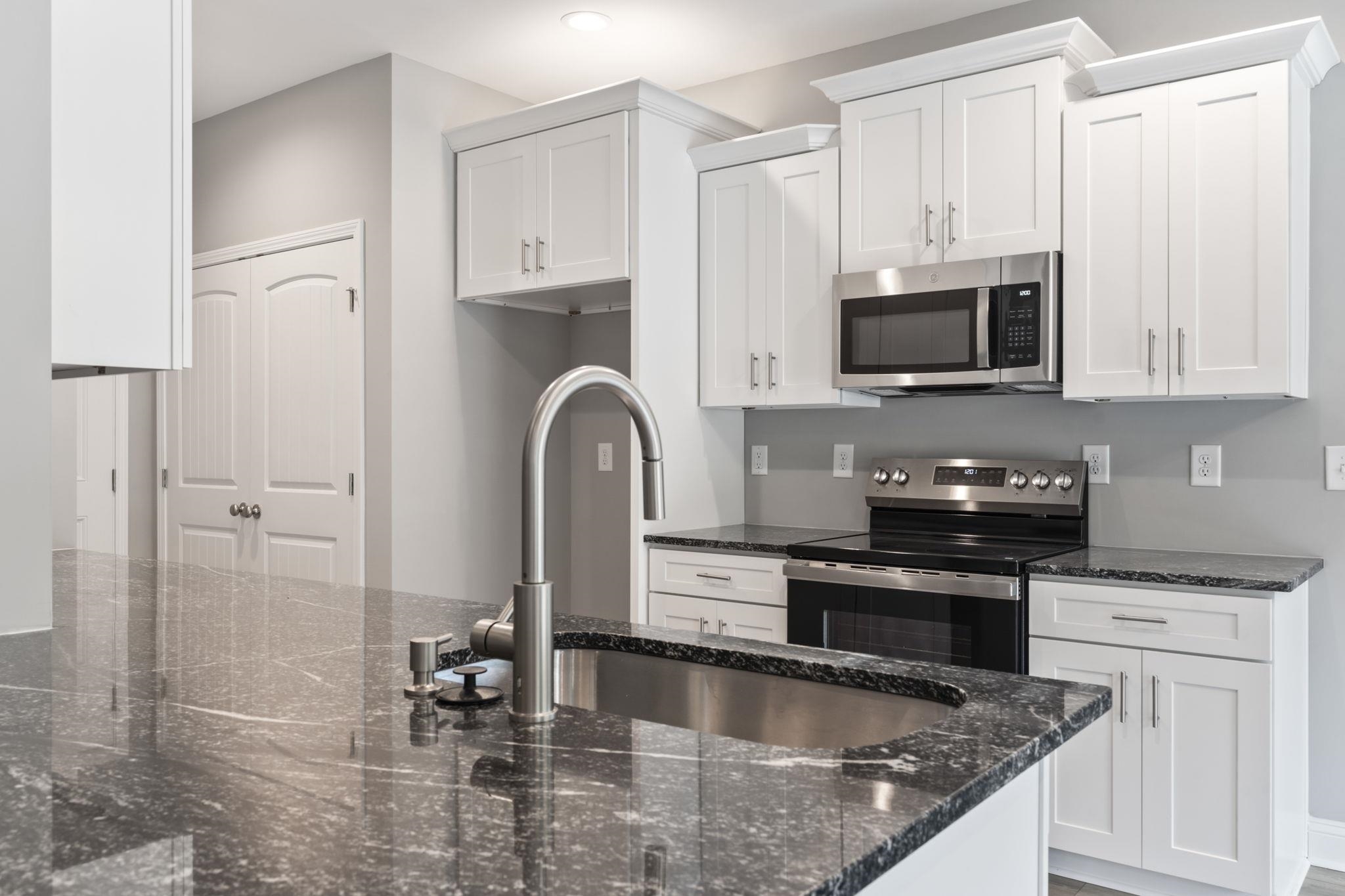 565 Timber Creek Drive Loris, SC 29569 - Photo 21 of 37 Kitchen with appliances with stainless steel finishes, dark stone countertops, white cabinetry, and recessed lighting
