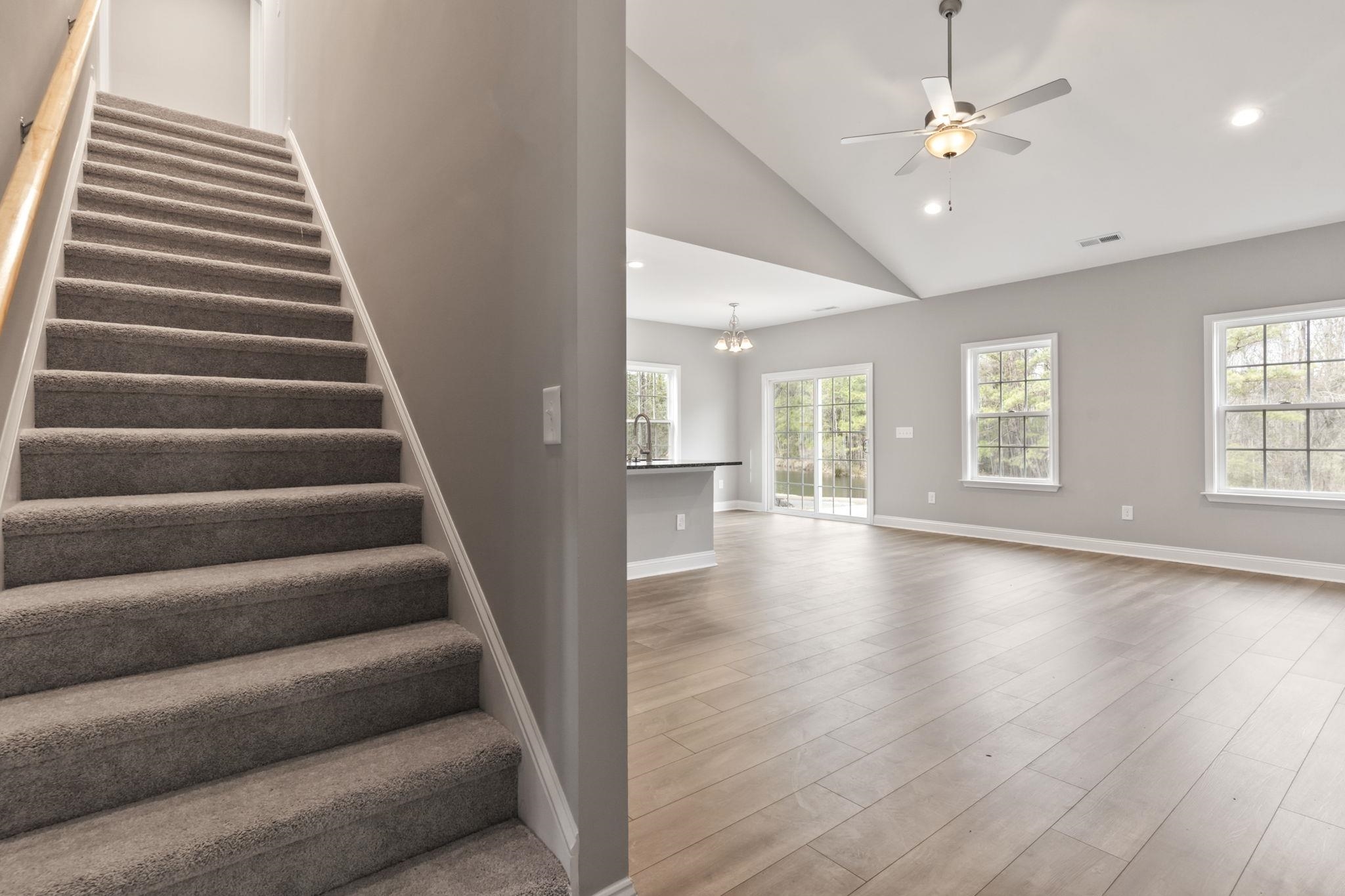 565 Timber Creek Drive Loris, SC 29569 - Photo 23 of 37 Staircase featuring recessed lighting, a chandelier, wood finished floors, a high ceiling, and a ceiling fan