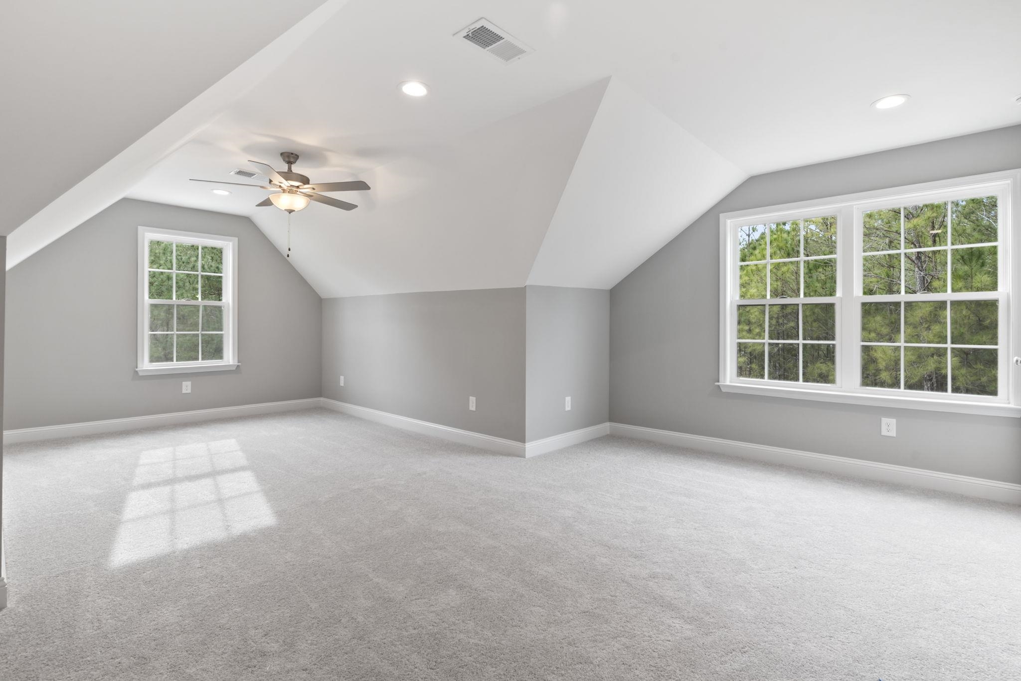 565 Timber Creek Drive Loris, SC 29569 - Photo 25 of 37 Additional living space featuring lofted ceiling, light carpet, ceiling fan, and recessed lighting
