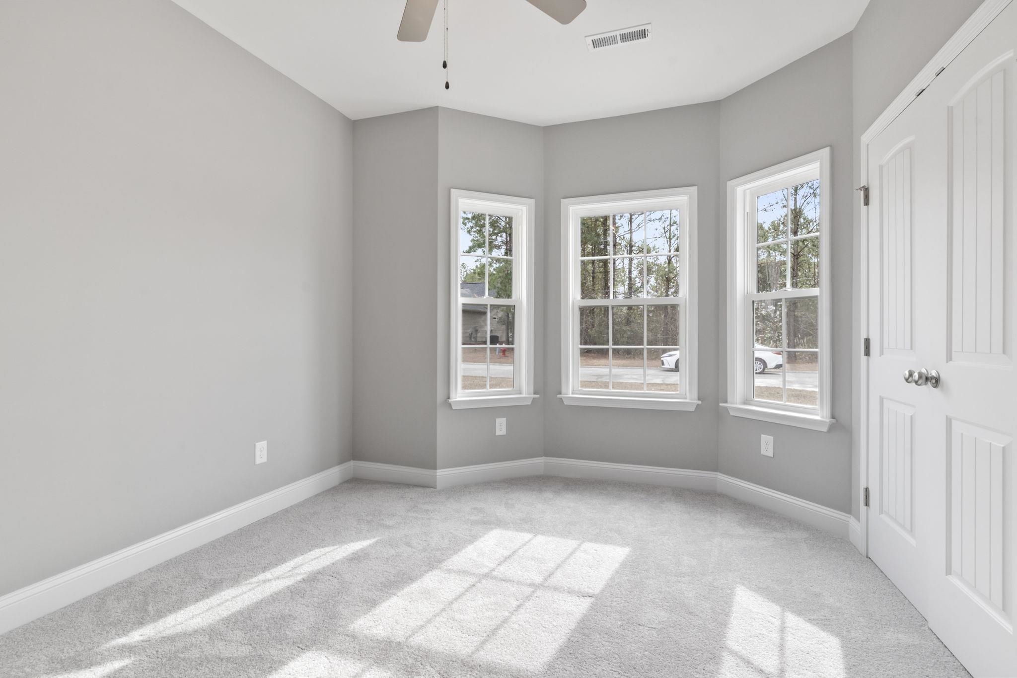 565 Timber Creek Drive Loris, SC 29569 - Photo 7 of 37 Spare room with healthy amount of natural light, light carpet, and a ceiling fan