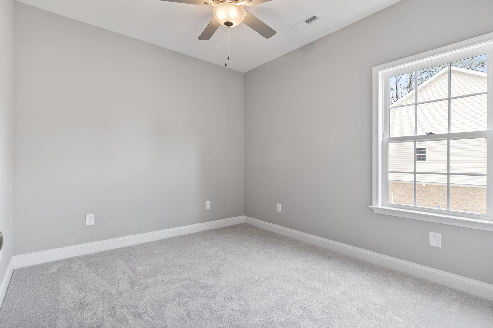 565 Timber Creek Drive Loris, SC 29569 - Photo 10 of 37 Carpeted empty room with baseboards and a ceiling fan