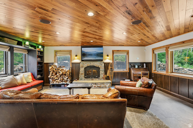10205 East Moose Loop Road Salt Lake City, UT 84121 - Photo 5 of 50 Living space featuring a stone-clad fireplace with a wood-burning insert