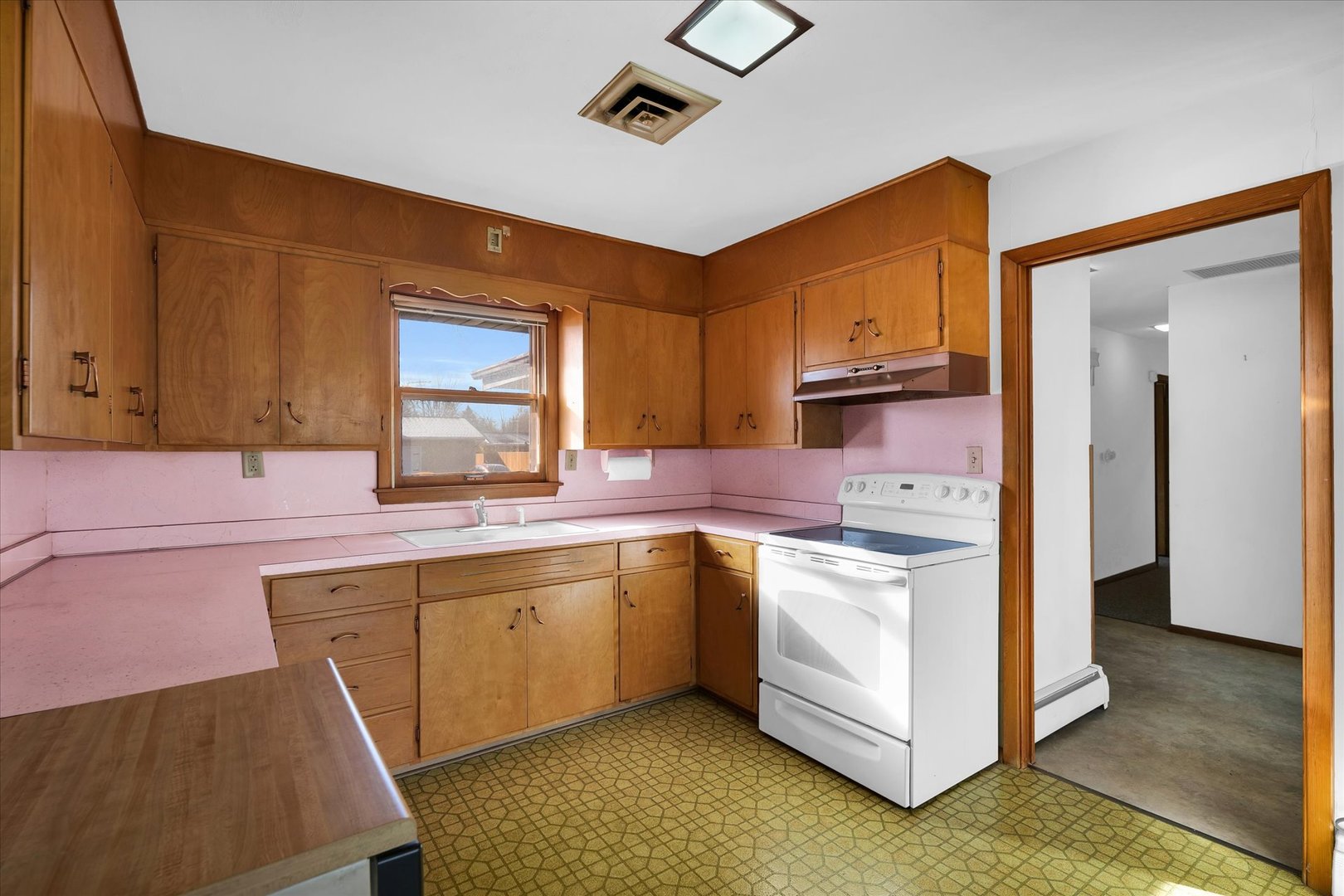 2406 John Drive Urbana, IL 61802 - Photo 10 of 28 a kitchen with a sink stove and cabinets