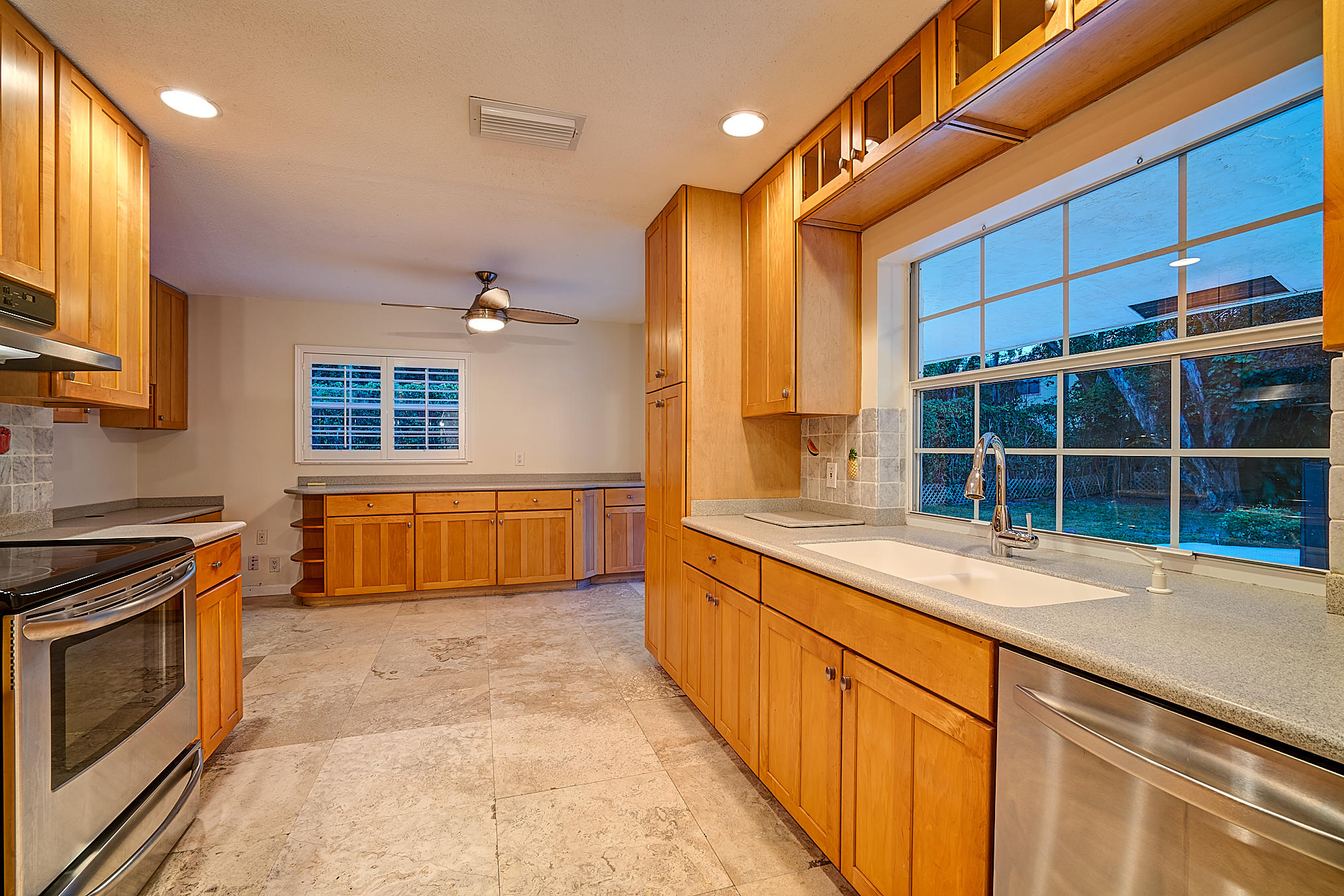 1120 Southwest 20th Street Boca Raton, FL 33486 - Photo 11 of 53 a view of a kitchen with stainless steel appliances granite countertop a stove and a sink