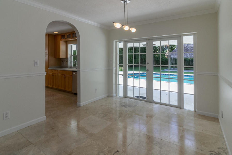1120 Southwest 20th Street Boca Raton, FL 33486 - Photo 20 of 53 a view of a room with large windows and a chandelier