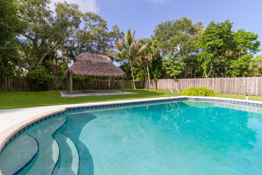1120 Southwest 20th Street Boca Raton, FL 33486 - Photo 2 of 53 a view of a swimming pool with a yard