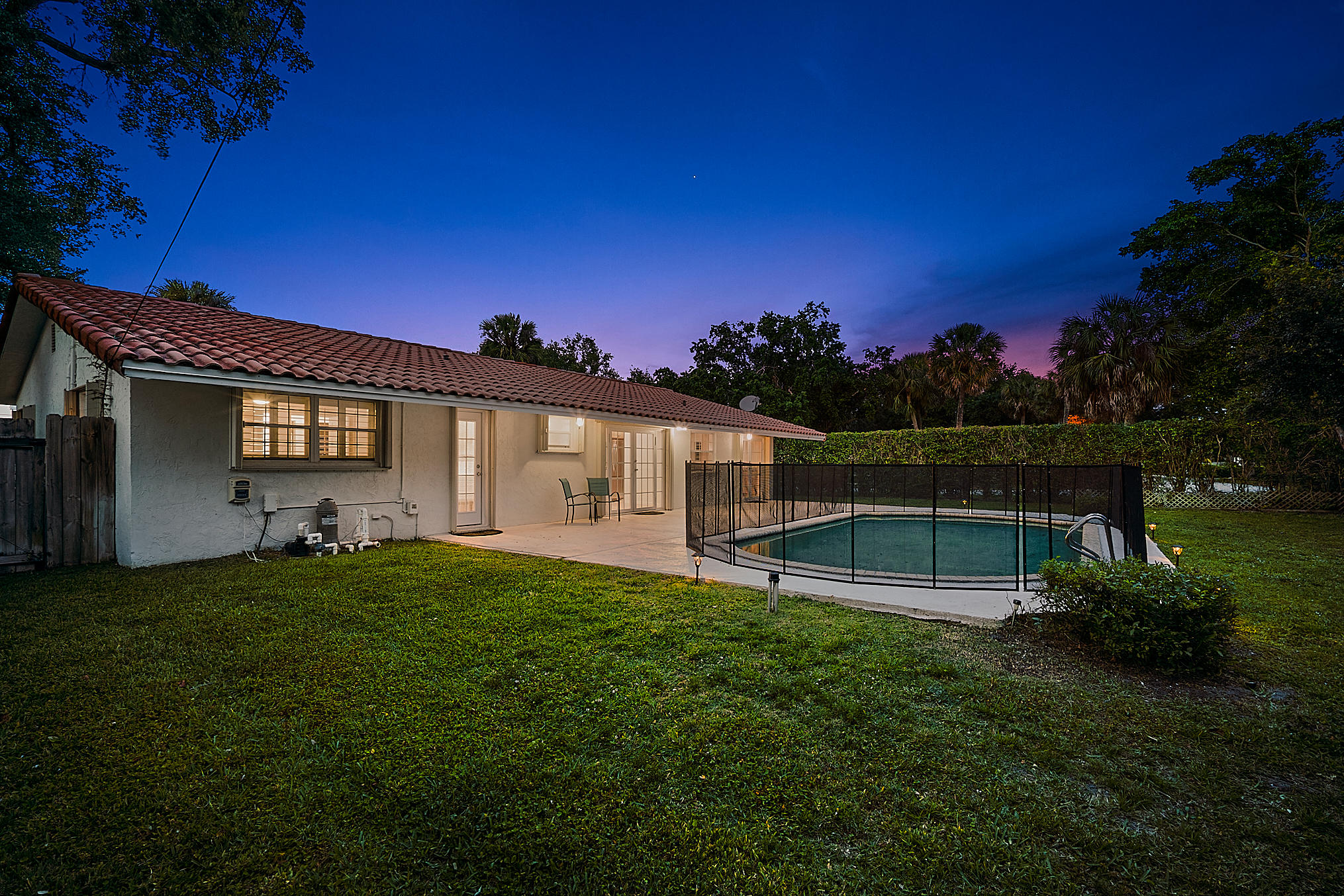 1120 Southwest 20th Street Boca Raton, FL 33486 - Photo 31 of 53 a front view of a house with a garden
