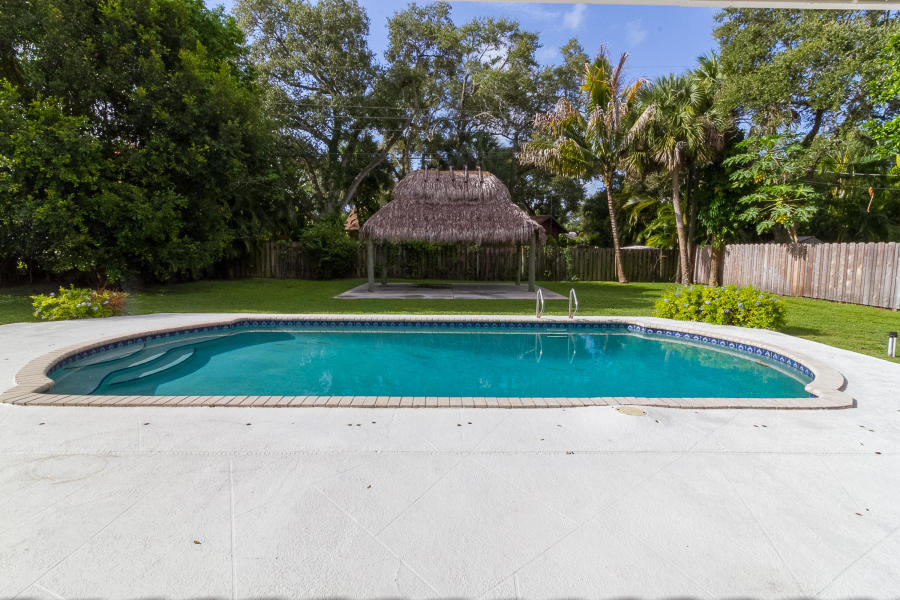 1120 Southwest 20th Street Boca Raton, FL 33486 - Photo 36 of 53 a view of a swimming pool and a yard