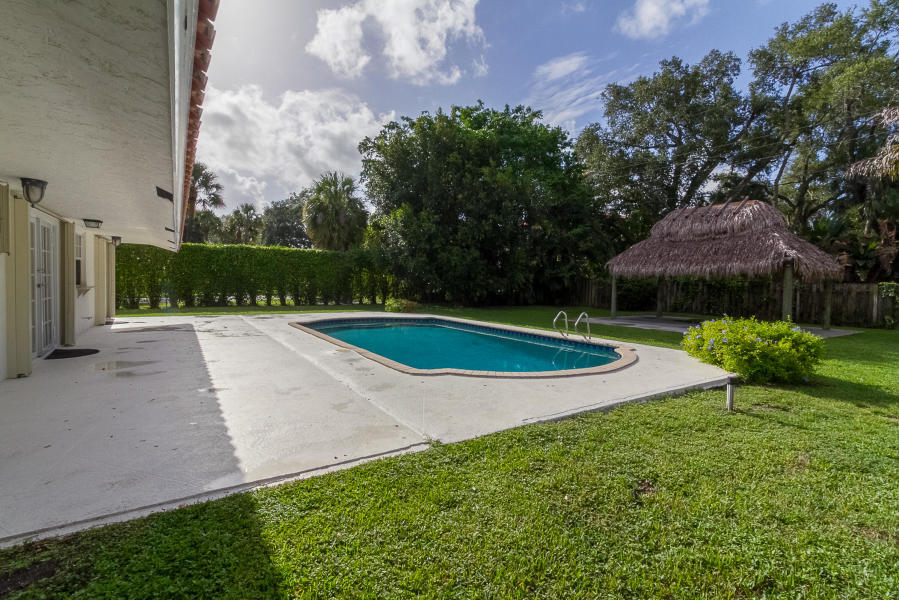 1120 Southwest 20th Street Boca Raton, FL 33486 - Photo 37 of 53 a view of a swimming pool with a yard