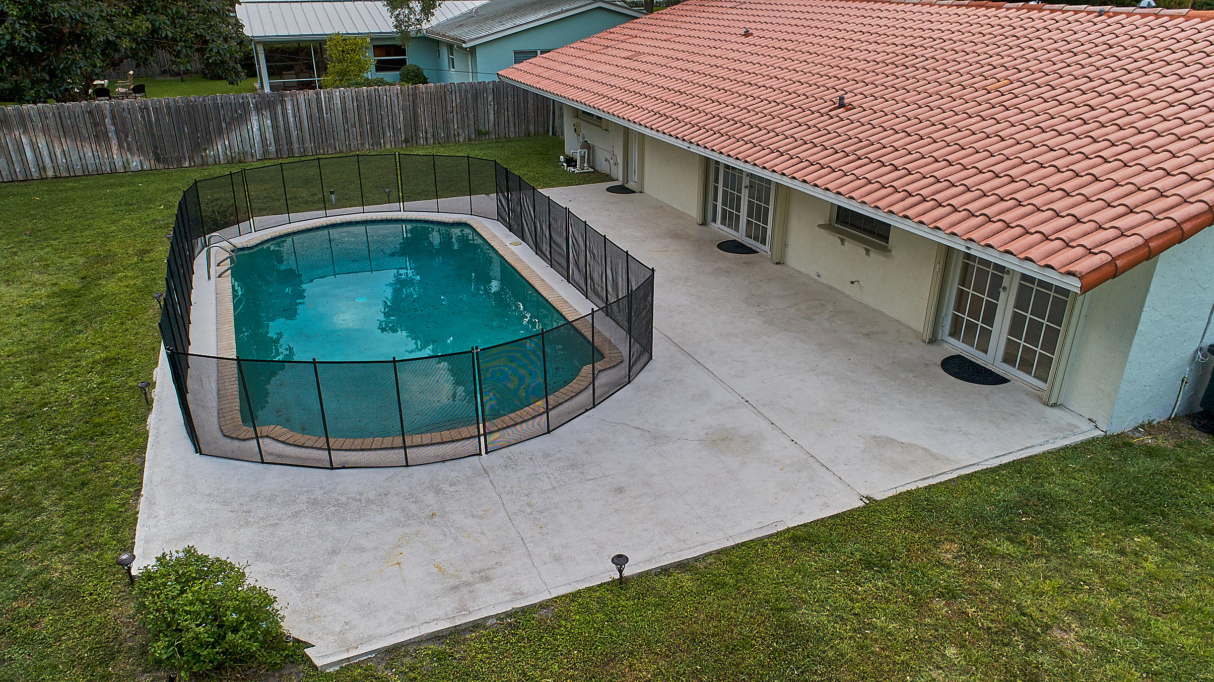 1120 Southwest 20th Street Boca Raton, FL 33486 - Photo 42 of 53 a backyard of a house with table and chairs