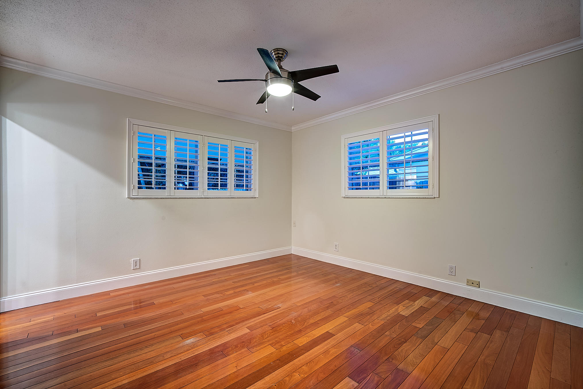 1120 Southwest 20th Street Boca Raton, FL 33486 - Photo 45 of 53 a view of empty room with wooden floor and ceiling fan
