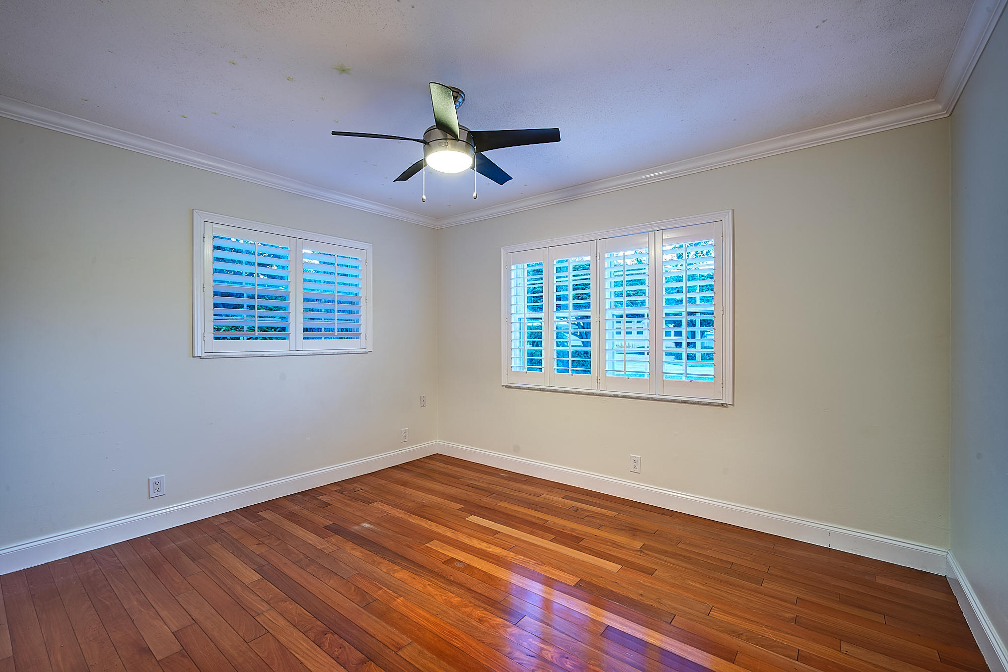 1120 Southwest 20th Street Boca Raton, FL 33486 - Photo 46 of 53 a view of an empty room with wooden floor and a window