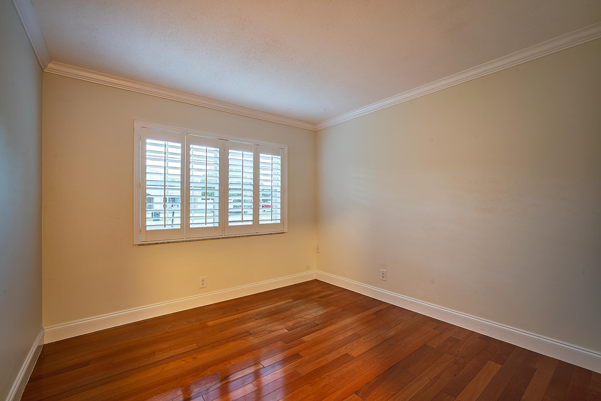 1120 Southwest 20th Street Boca Raton, FL 33486 - Photo 47 of 53 wooden floor in an empty room with a window