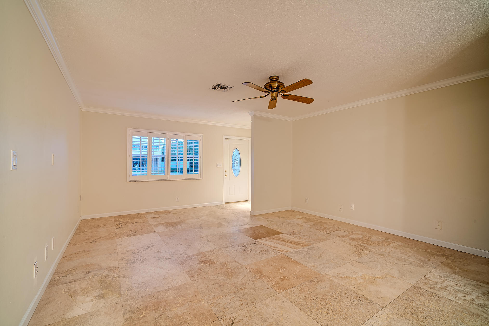 1120 Southwest 20th Street Boca Raton, FL 33486 - Photo 48 of 53 an empty room with a window and a ceiling fan