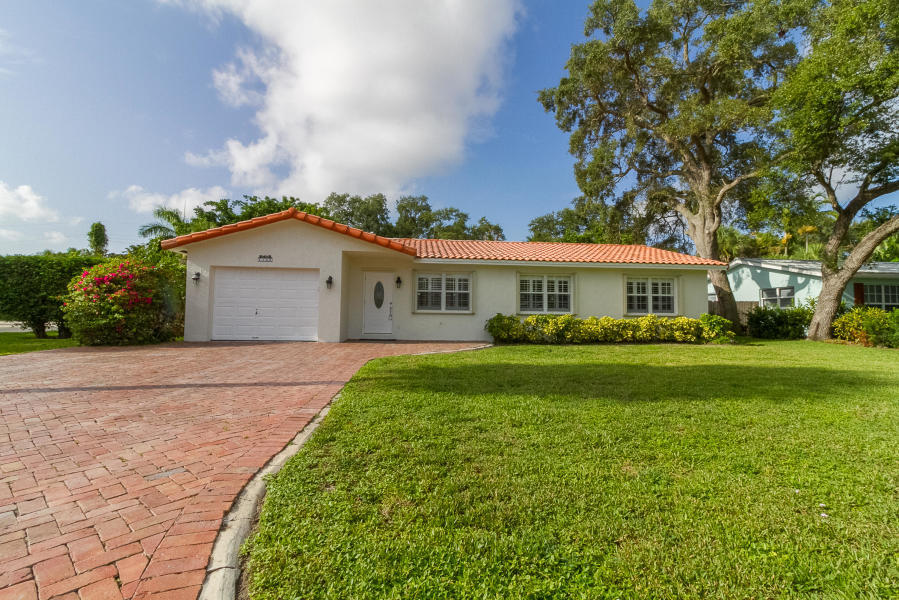 1120 Southwest 20th Street Boca Raton, FL 33486 - Photo 8 of 53 a front view of a house with a yard