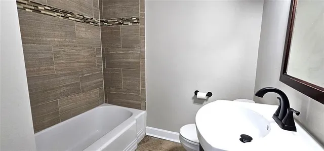 a bathroom with a sink a shower and bathtub