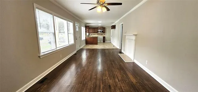 a view of entryway and kitchen with wooden floor