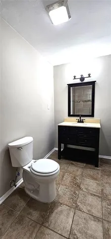 a bathroom with a toilet a sink and a mirror