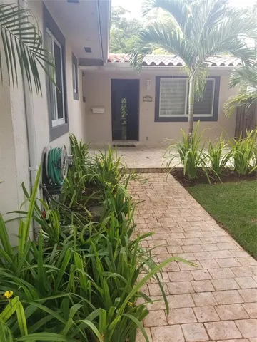 a front view of a house with garden