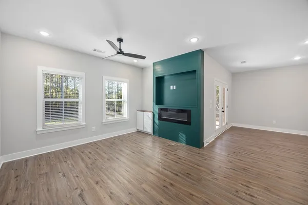 a living room with kitchen island furniture and a wooden floor
