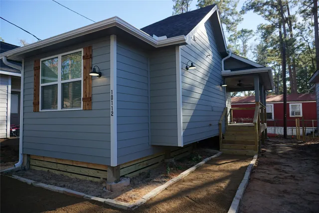 a front view of a house with a garden
