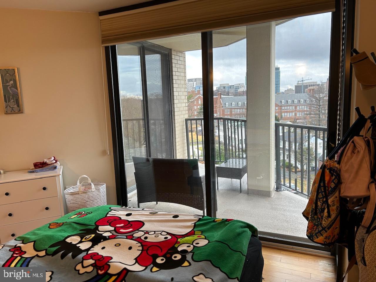 4242 East-West Highway, Unit 708 Chevy Chase, MD 20815 - Photo 11 of 12 a bedroom with a bed and a window