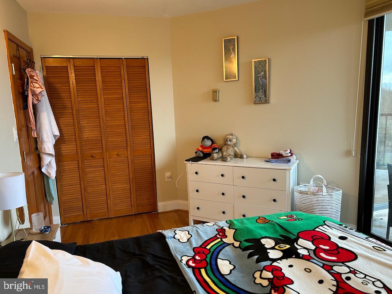 4242 East-West Highway, Unit 708 Chevy Chase, MD 20815 - Photo 12 of 12 a bed room with a bed and a dresser