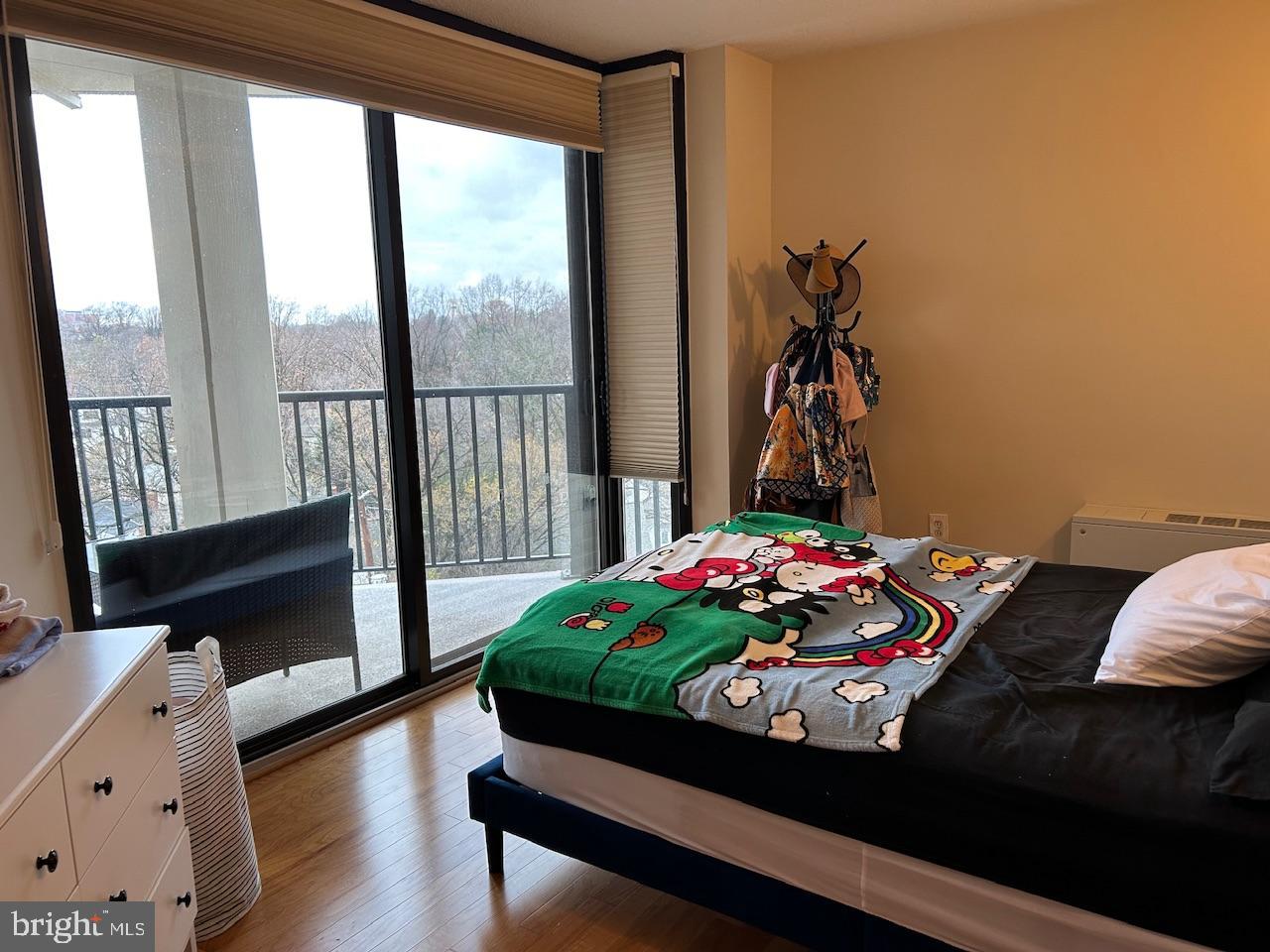 4242 East-West Highway, Unit 708 Chevy Chase, MD 20815 - Photo 10 of 12 a living room with a bed and a window