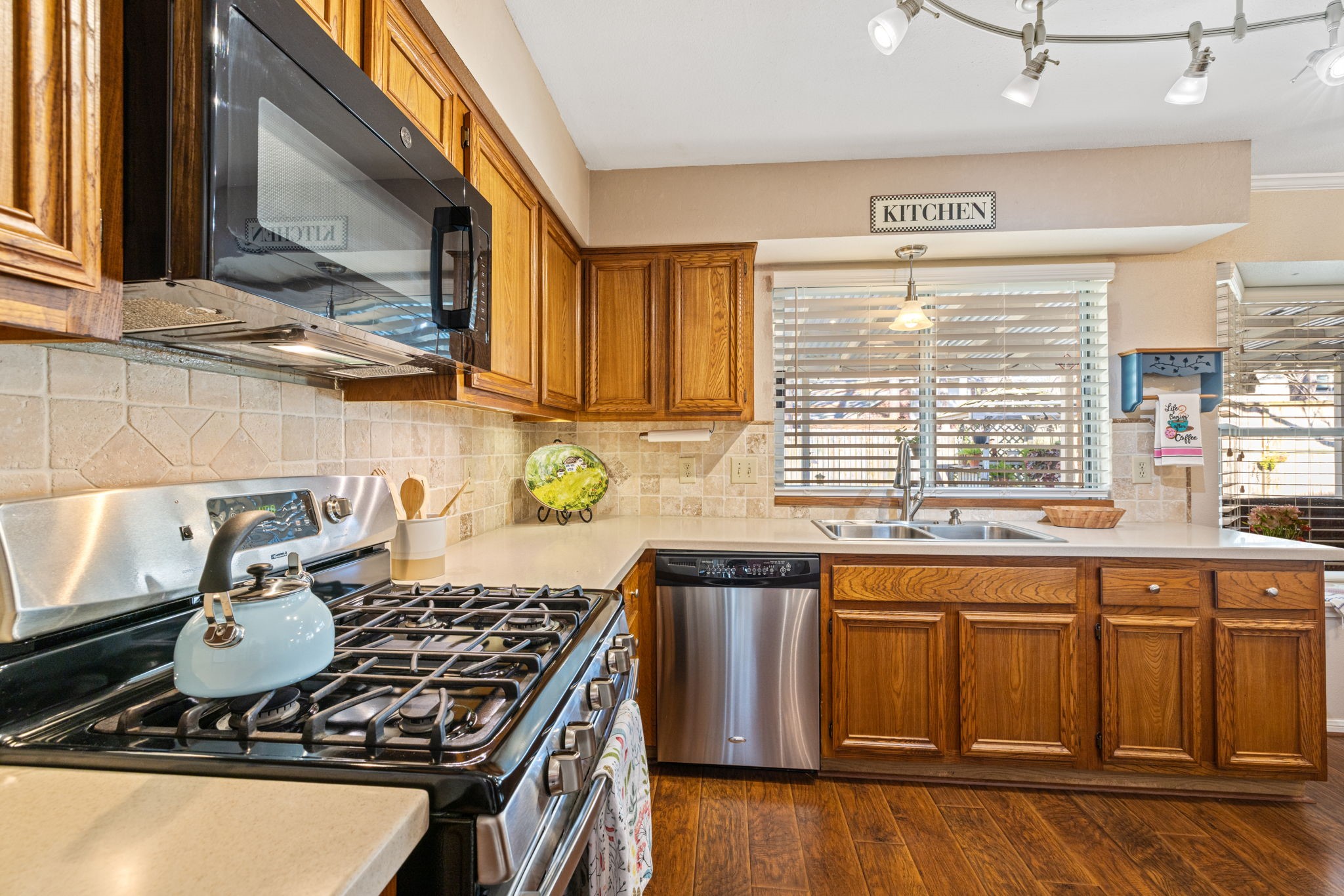 9102 Woodhouse Drive Spring, TX 77379 - Photo 10 of 32 KITCHEN - Nice 5-burner gas range. Microwave replaced 2021.