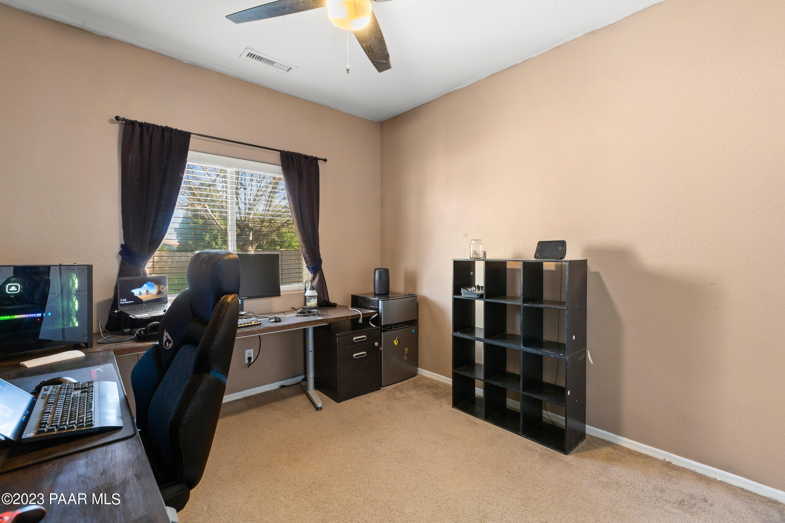 6622 Farmstead Road Prescott Valley, AZ 86314 - Photo 12 of 14 a view of a workspace with furniture and a window