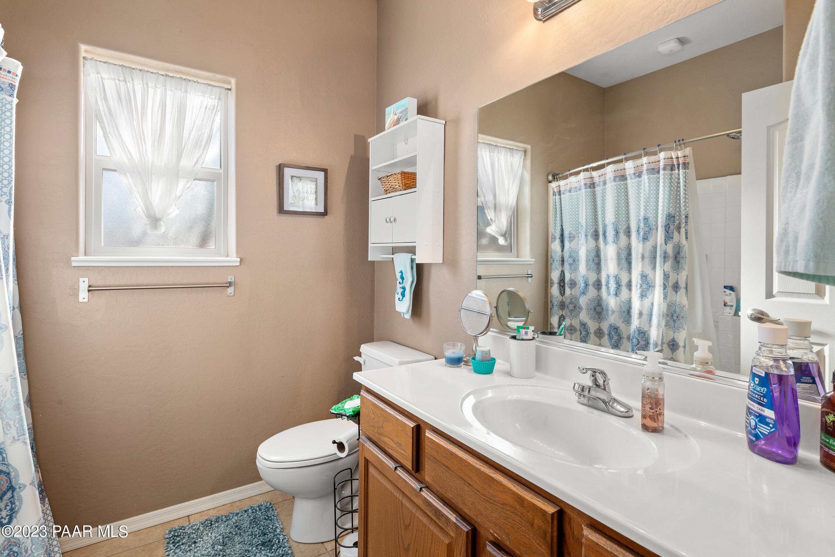 6622 Farmstead Road Prescott Valley, AZ 86314 - Photo 14 of 14 a bathroom with a sink a toilet and shower curtain