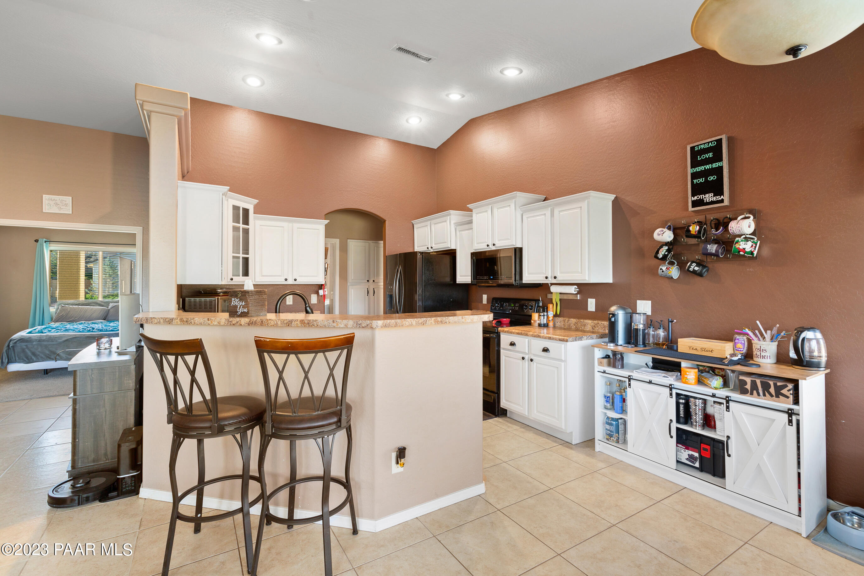 6622 Farmstead Road Prescott Valley, AZ 86314 - Photo 7 of 14 a kitchen with a sink stainless steel appliances and white cabinets