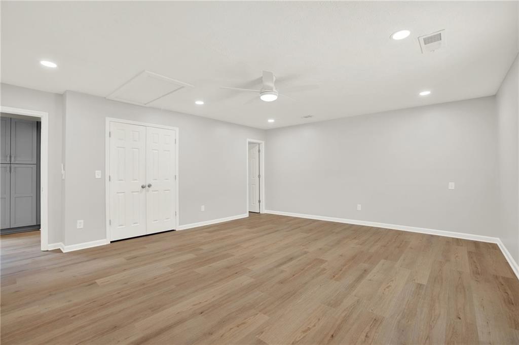 76 Picklesimer Road Southwest Cartersville, GA 30120 - Photo 16 of 43 an empty room with wooden floor and windows