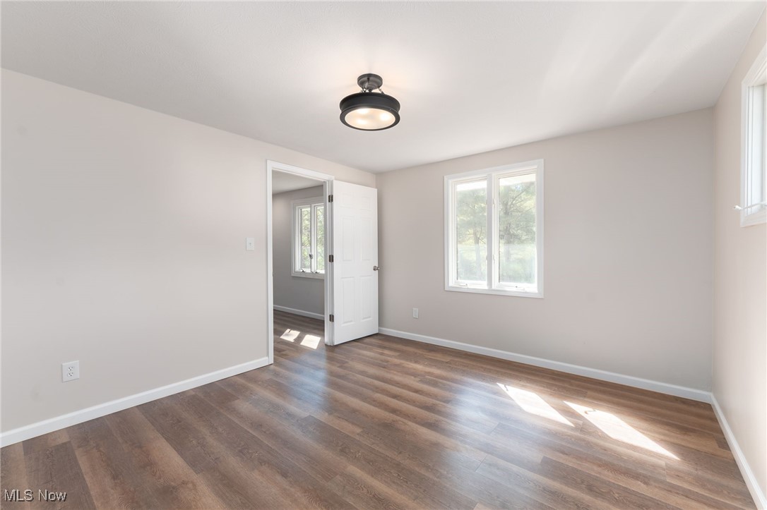 13295 Sperry Road Chesterland, OH 44026 - Photo 27 of 35 Empty room with dark wood-type flooring and plenty of natural light